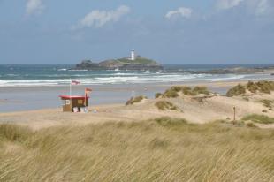 View of Godrevy Islandand lighthouse and the beach and sand dunes of Gwithian Towans